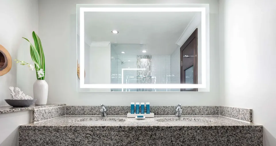 Club Room bathroom vanity with illuminated mirror at Sandals Grande St. Lucian.