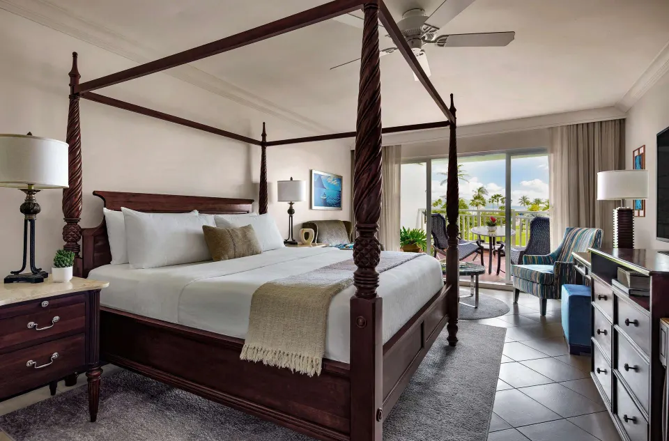 Club Room king four-poster bed and balcony at Sandals Grande St. Lucian.