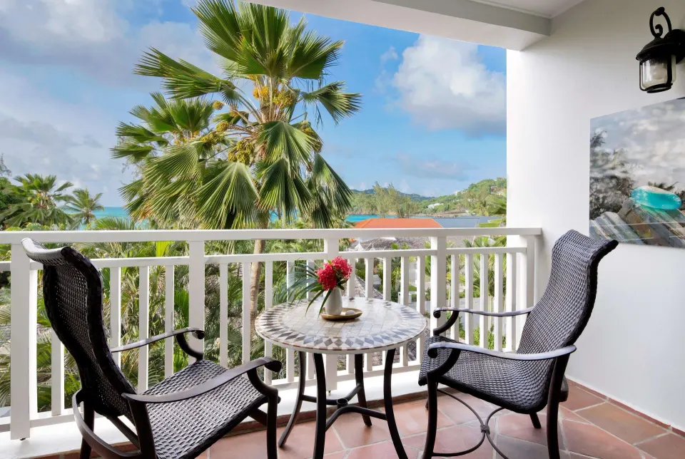 Furnished partial ocean view balcony for a Club Room at Sandals Grande St. Lucian.