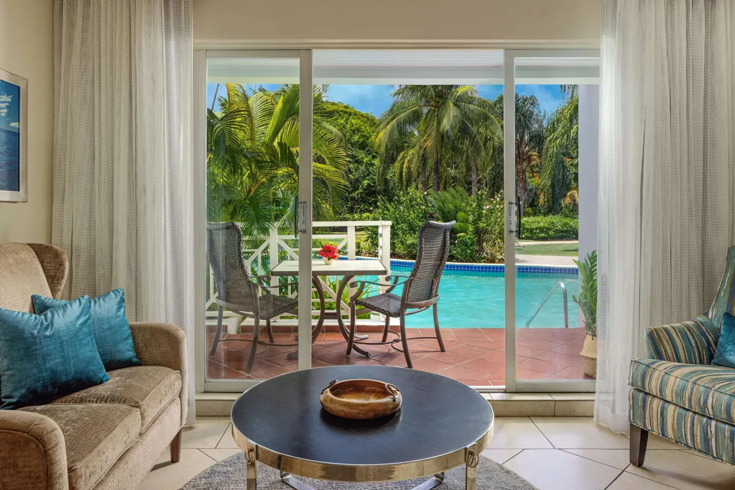 Club Room sitting area with sliding doors to the pool patio at Sandals Grande St. Lucian.