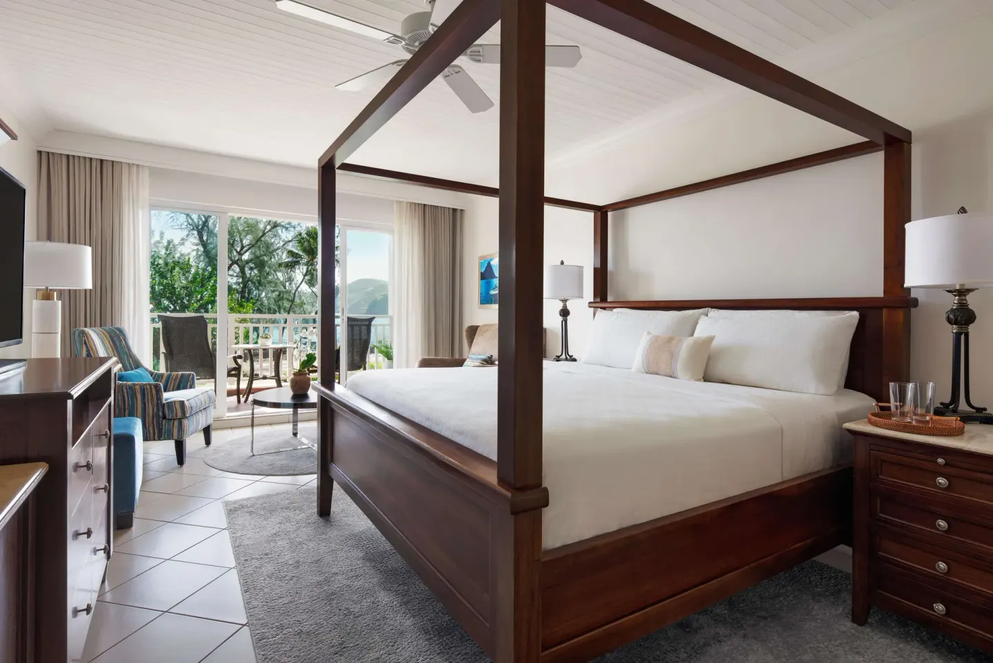 Caribbean Walkout Deluxe room with four-poster king bed at Sandals Grande St. Lucian.