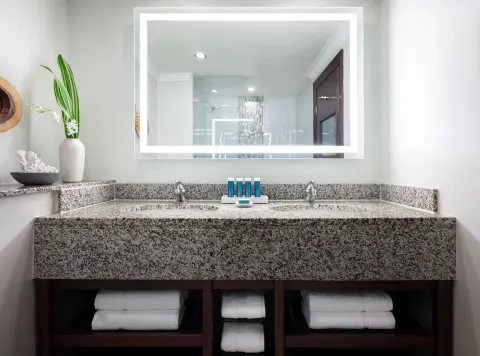 Granite double-sink bathroom vanity in a honeymoon room at Sandals Grande St. Lucian.