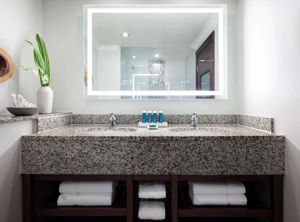Granite double-sink bathroom vanity in a honeymoon room at Sandals Grande St. Lucian.