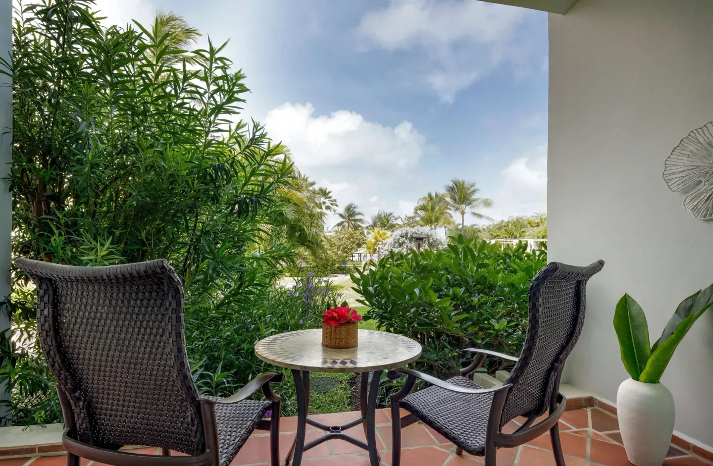 Garden patio seating for a honeymoon pool view room at Sandals Grande St. Lucian.