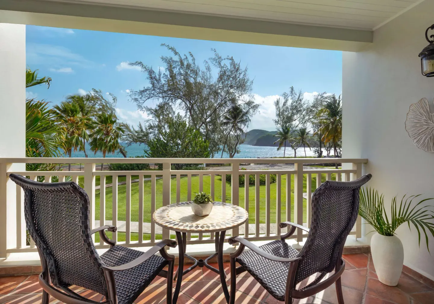 Ocean-view balcony seating for a Luxury Room at Sandals Grande St. Lucian.