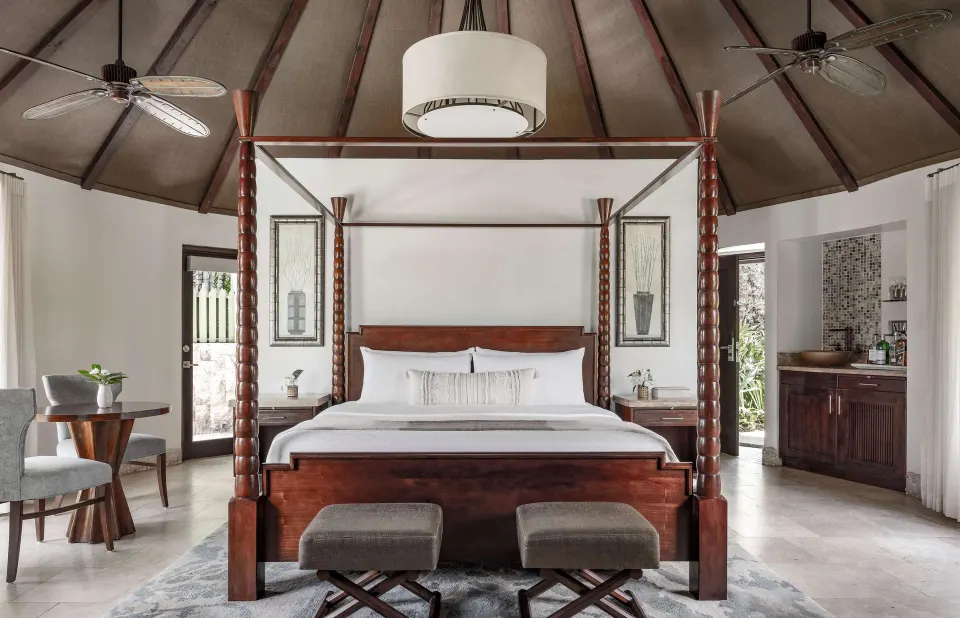 Luxury rondoval suite bedroom with four-poster bed at Sandals Grande St. Lucian.