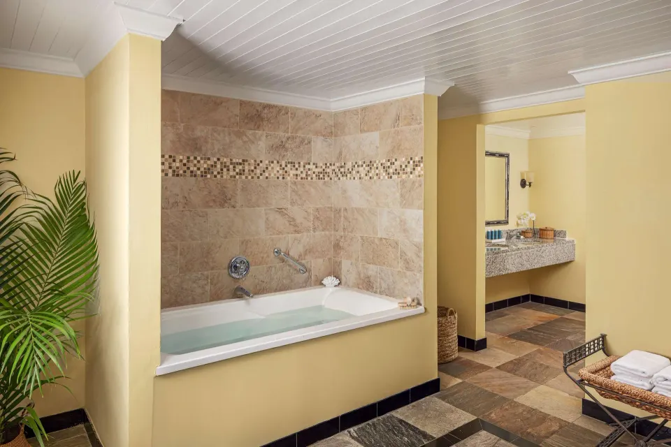 Spacious bathroom with soaking tub in a luxury suite at Sandals Grande St. Lucian.