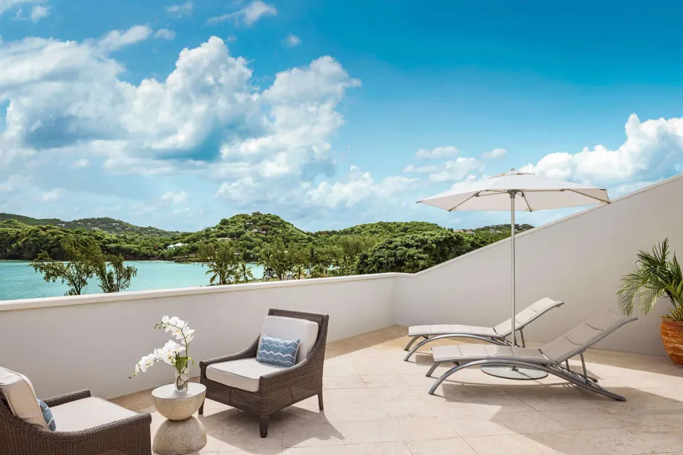 Private terrace with loungers and water view at Sandals Grande St. Lucian.