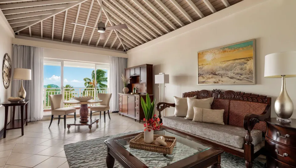 One-bedroom ocean view suite living room with balcony at Sandals Grande St. Lucian.