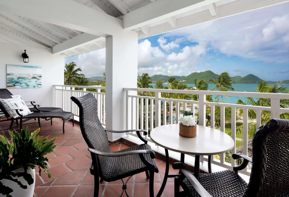 Ocean view balcony with wicker seating at Sandals Grande St. Lucian.