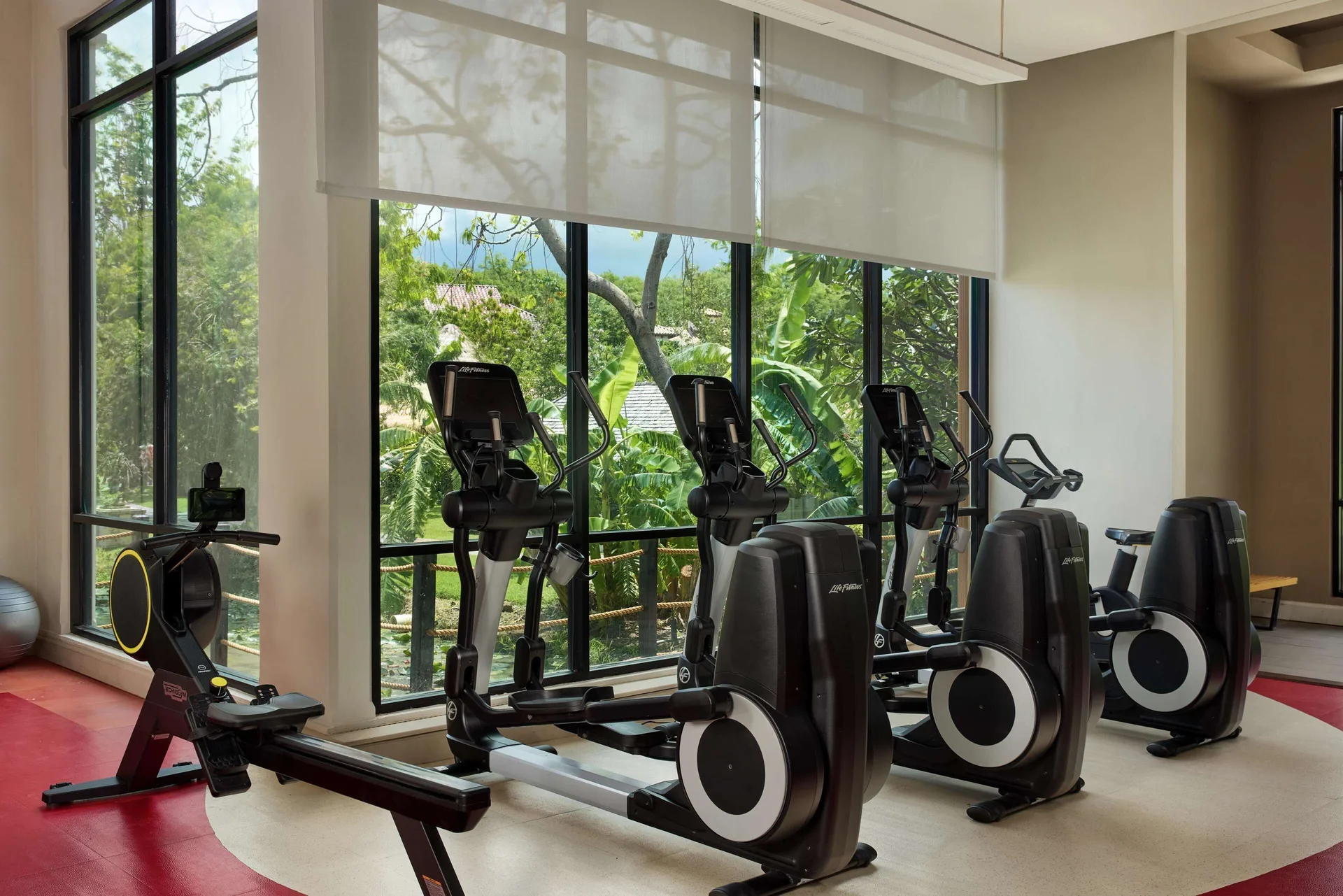 Fitness room with cardio machines and garden views at Sandals Grenada.