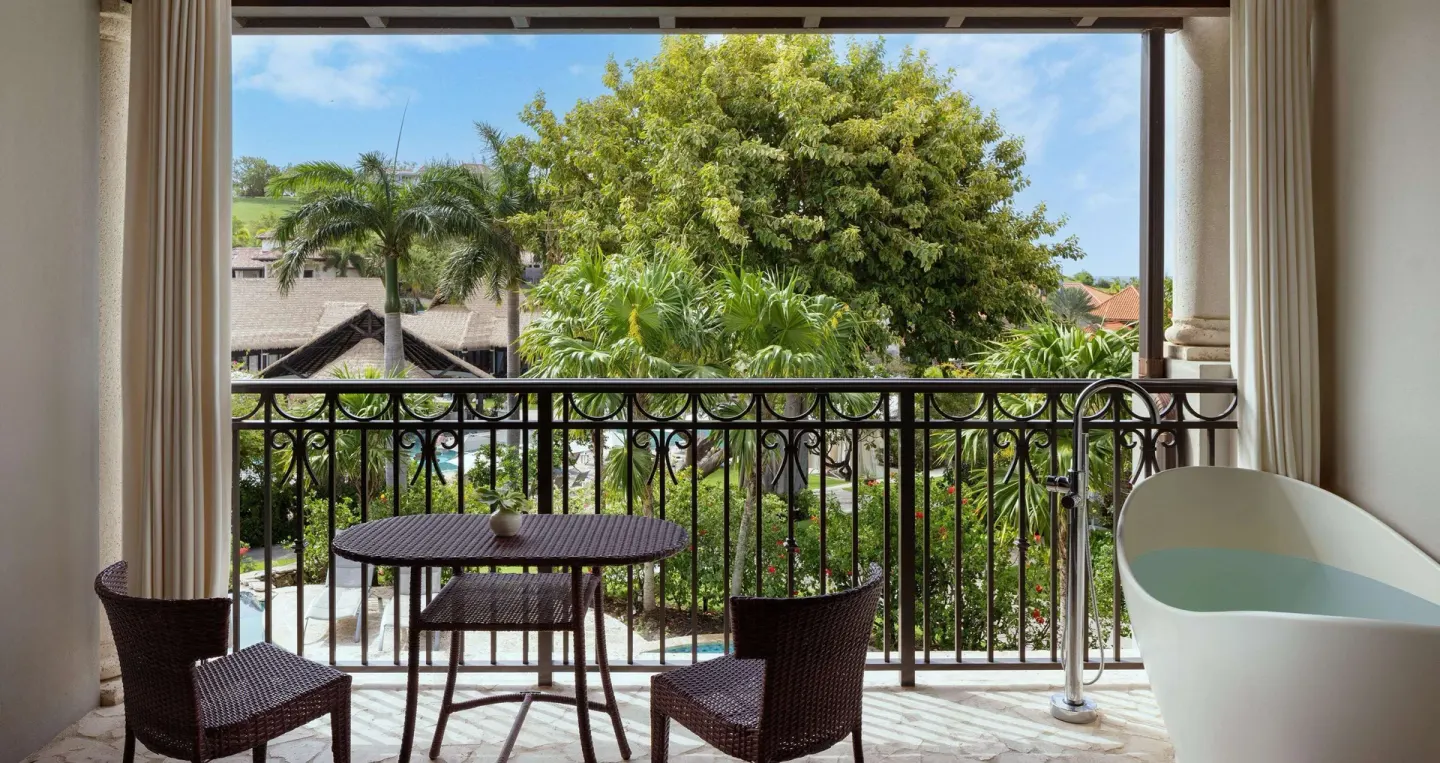 Balcony with soaking tub and garden view at Sandals Grenada.