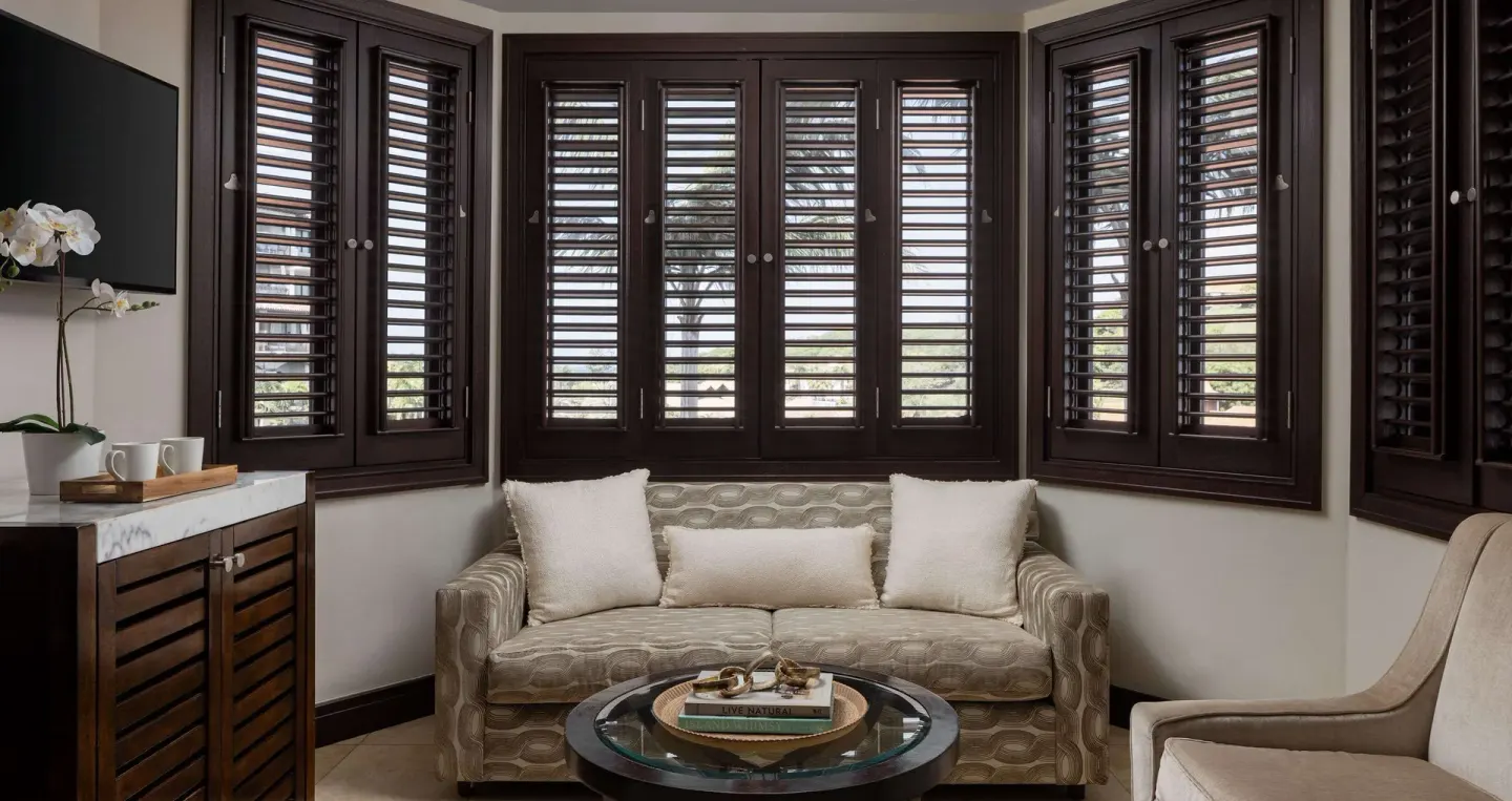Guest room sitting area with louvered shutters at Sandals Grenada.