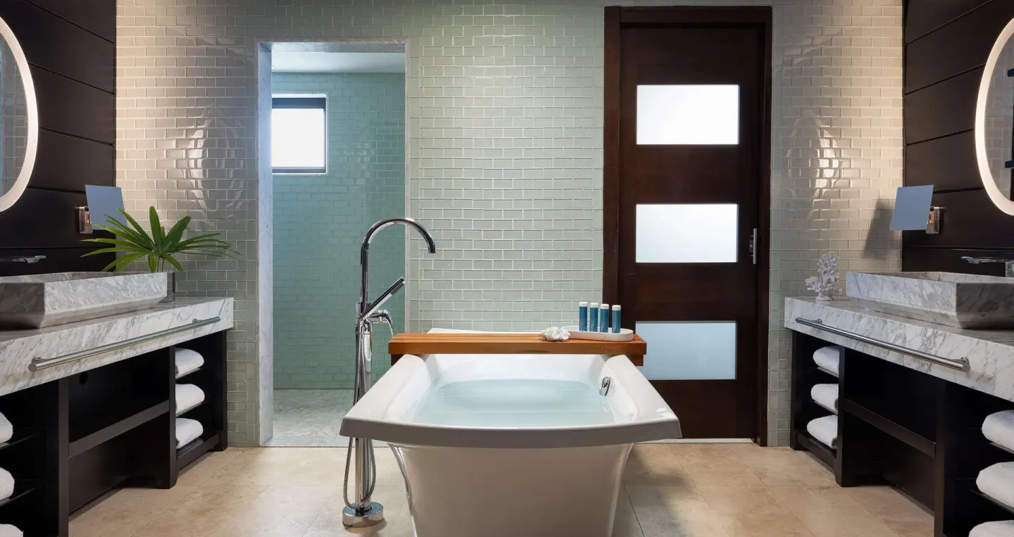 Modern bathroom with soaking tub and double vanities at Sandals Grenada.