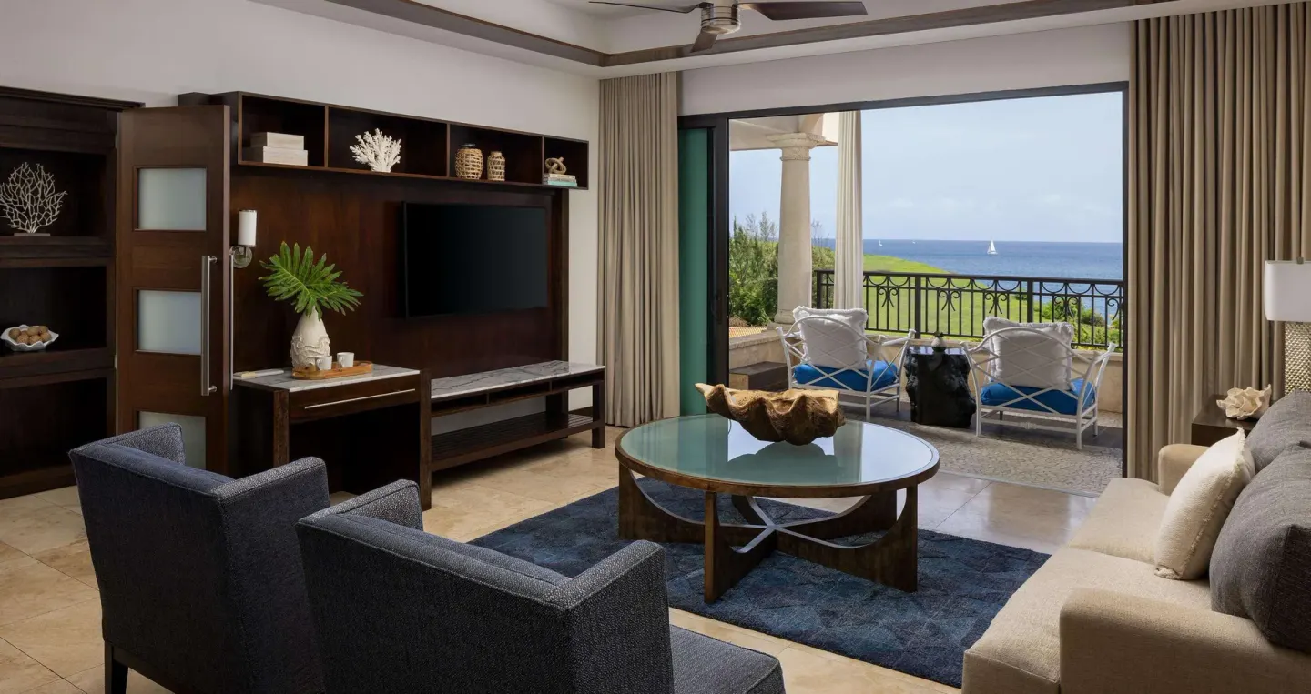 Ocean view living room with balcony seating at Sandals Grenada.