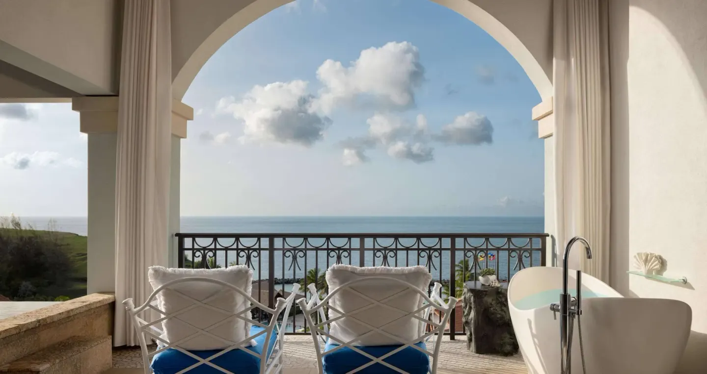 Oceanfront balcony with soaking tub and lounge chairs at Sandals Grenada.