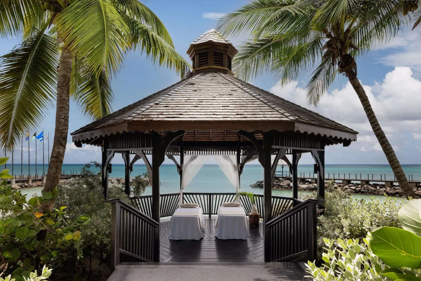 Oceanfront wedding gazebo with two massage tables at Sandals Grenada.