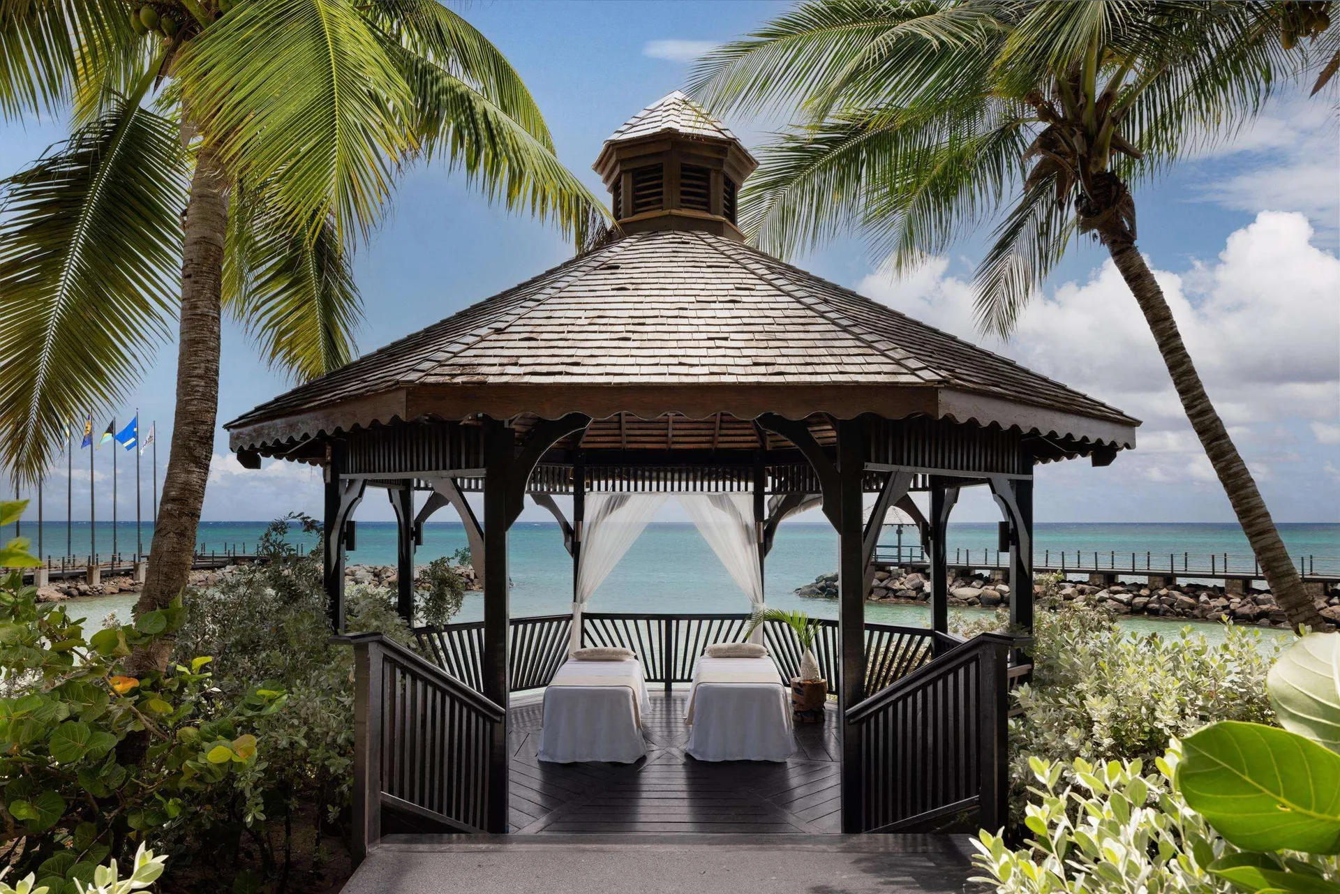 Oceanfront wedding gazebo with two massage tables at Sandals Grenada.