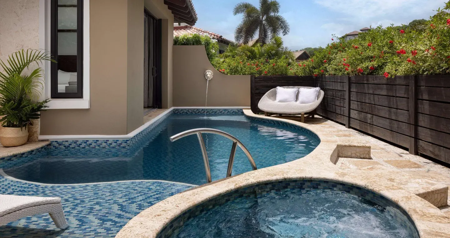 Private plunge pool and round spa with patio seating at Sandals Grenada.