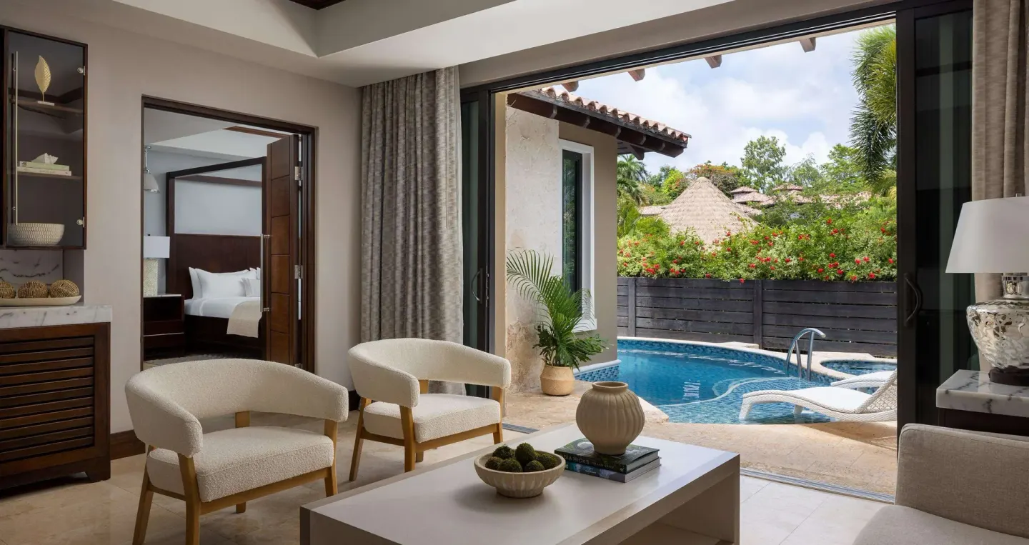 Living area opening to a private pool patio and bedroom at Sandals Grenada.