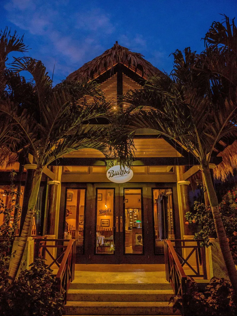 Butch's Chophouse entrance glowing at night at Sandals Grenada.