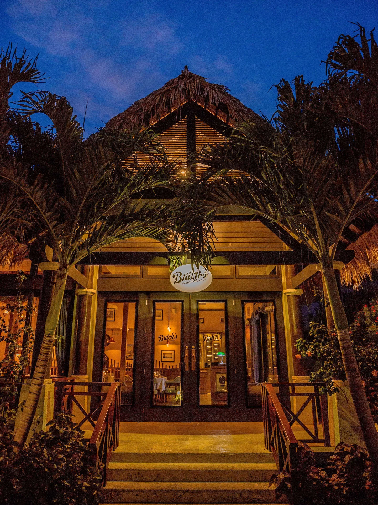 Butch's Chophouse entrance glowing at night at Sandals Grenada.