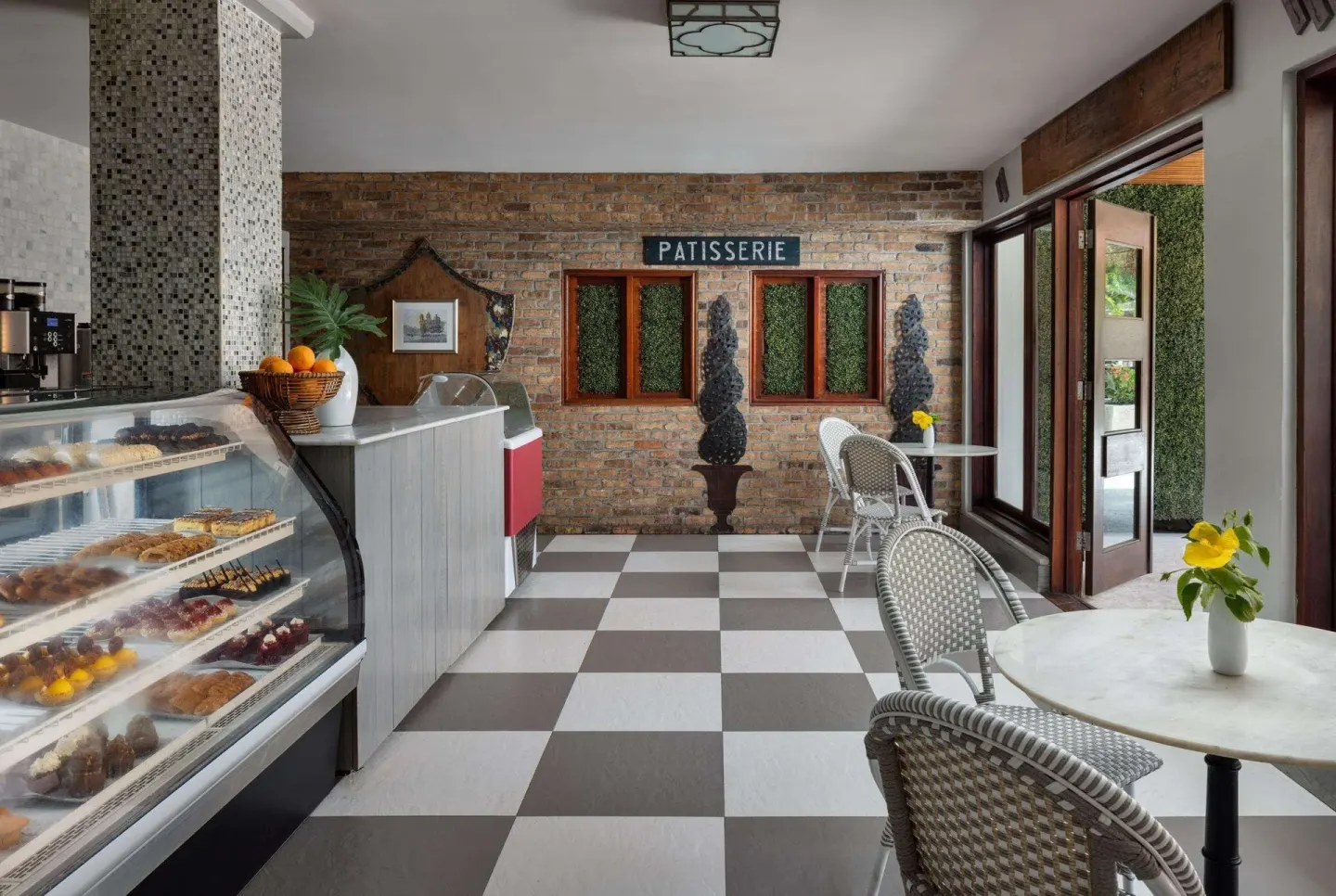 Café de Paris patisserie counter with pastries and café seating at Sandals Grenada.