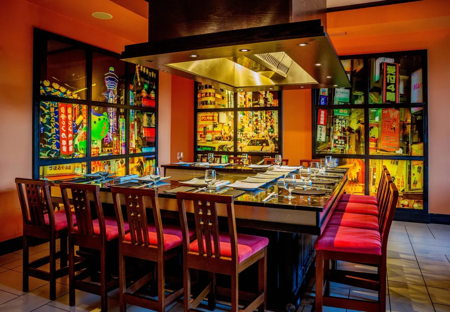 Kimonos teppanyaki table with red seating and colorful Japanese city murals at Sandals Grenada.