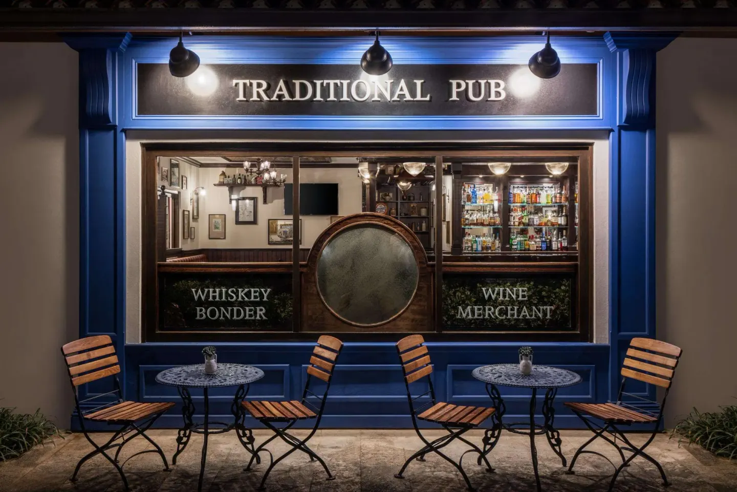 Traditional pub storefront with outdoor café tables at Sandals Grenada.
