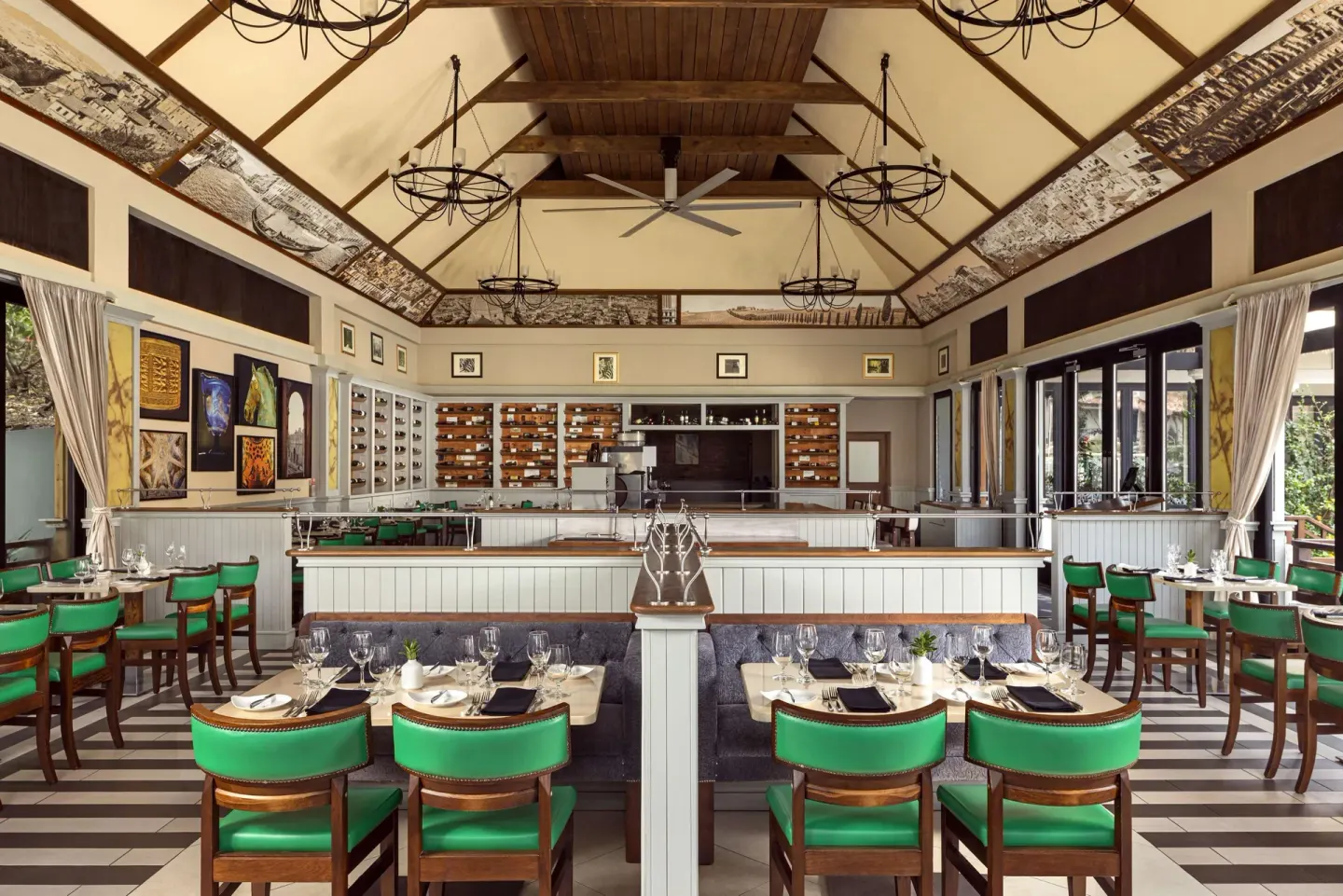Elegant wine-lined restaurant dining room with green chairs at Sandals Grenada.