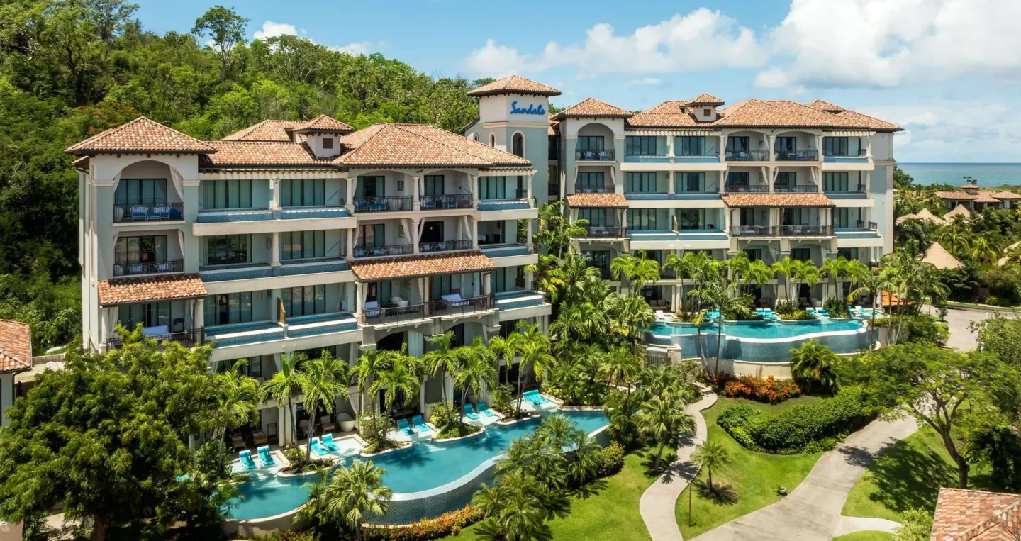 Exterior of garden-view suite buildings and pools at Sandals Grenada.