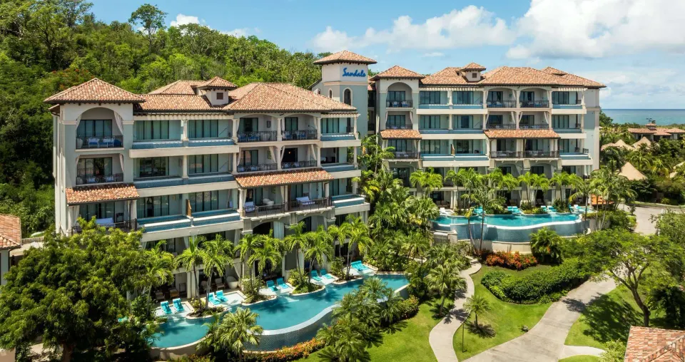 Exterior of garden-view suite buildings and pools at Sandals Grenada.