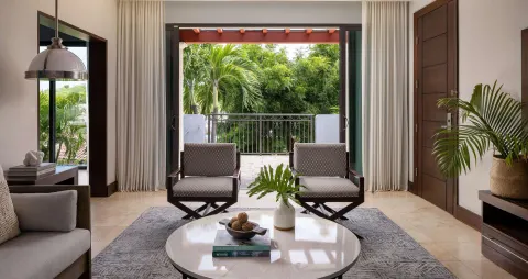 Living room of a Luxury Suite with garden balcony at Sandals Grenada.