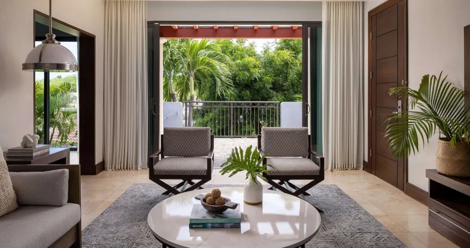 Living room of a Luxury Suite with garden balcony at Sandals Grenada.
