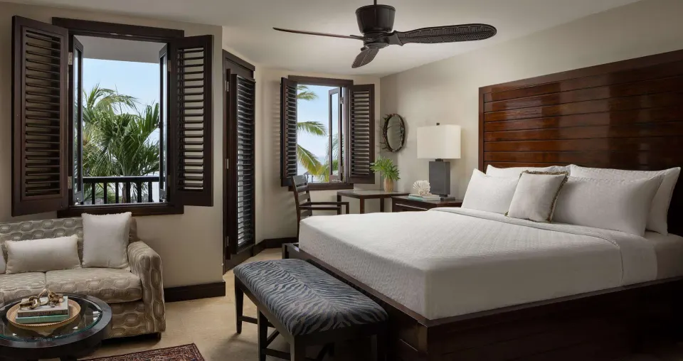 Pink Gin Beachfront Club Level Room with king bed and open shutters at Sandals Grenada.