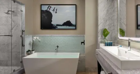 Suite bathroom with soaking tub, shower, and vanity at Sandals Grenada.