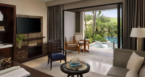 Living area opening to a swim-up patio and pool at Sandals Grenada.