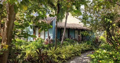 Garden path beside a thatched rondoval suite at Sandals Grenada.