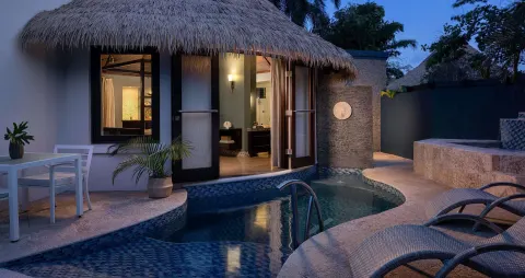 Private plunge pool outside a rondoval suite at dusk at Sandals Grenada.