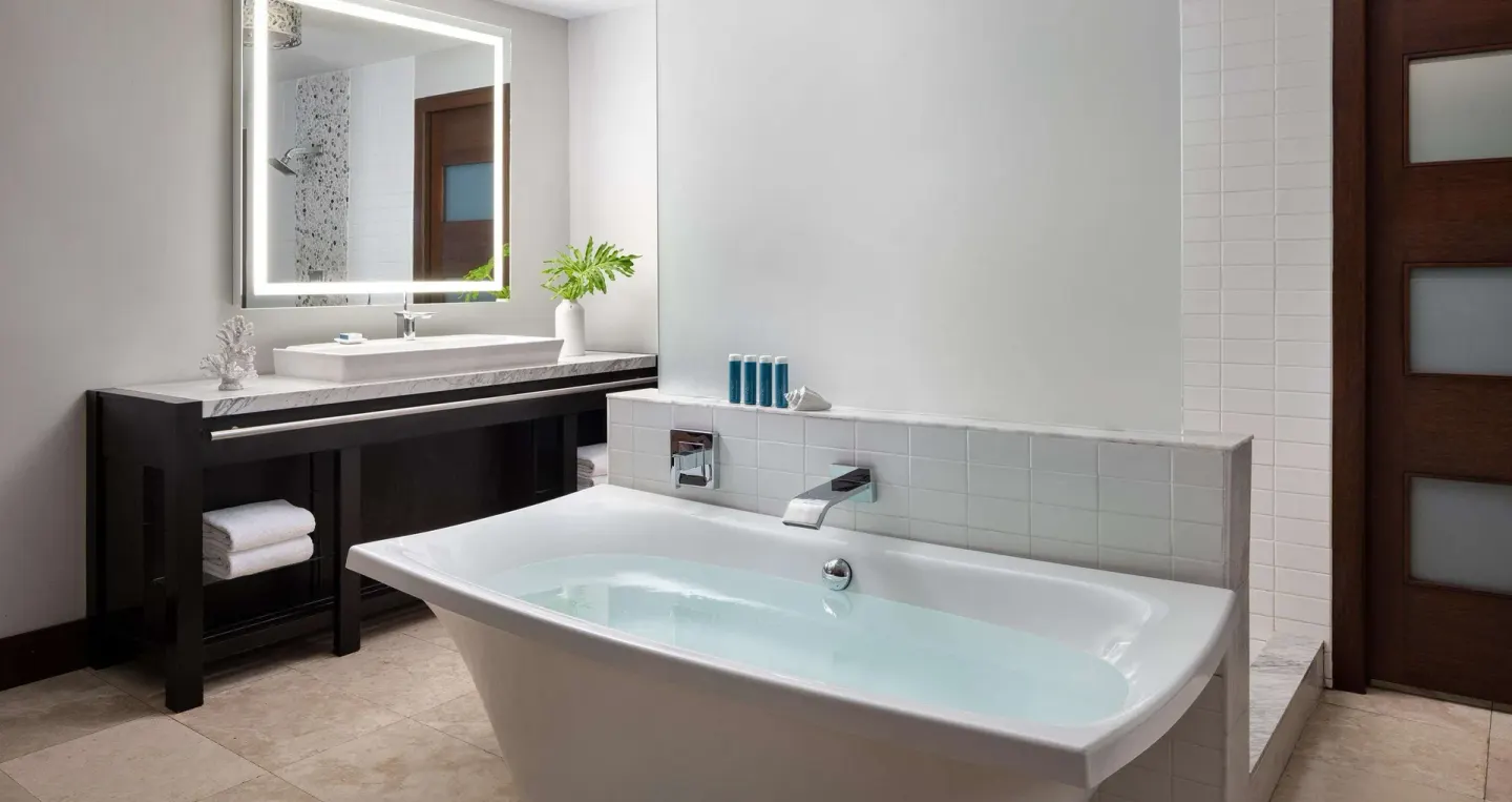 South Seas Walkout Junior Suite bathroom with tub and vanity at Sandals Grenada.