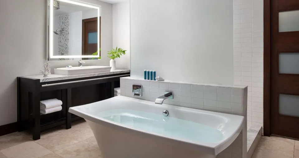 South Seas Walkout Junior Suite bathroom with tub and vanity at Sandals Grenada.