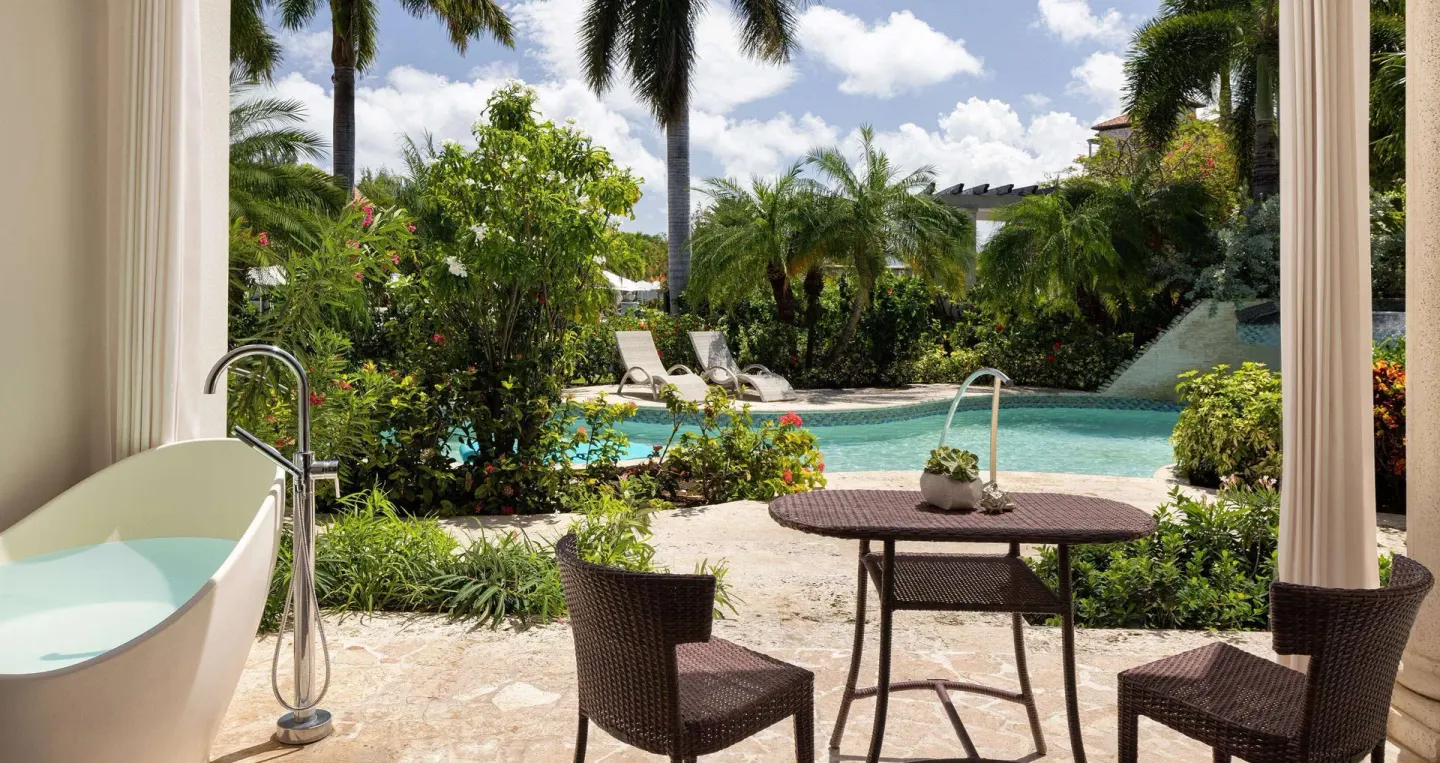 Walkout Junior Suite patio with soaking tub and pool garden at Sandals Grenada.