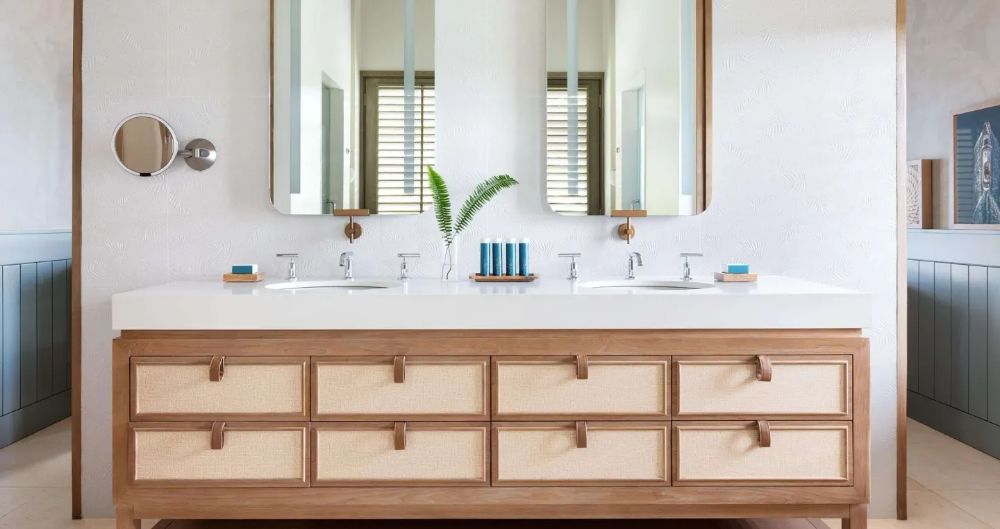 Double vanity bathroom with mirrors and bath amenities at Sandals Halcyon.