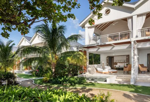 White guest suite buildings with patios and plunge pools at Sandals Halcyon.