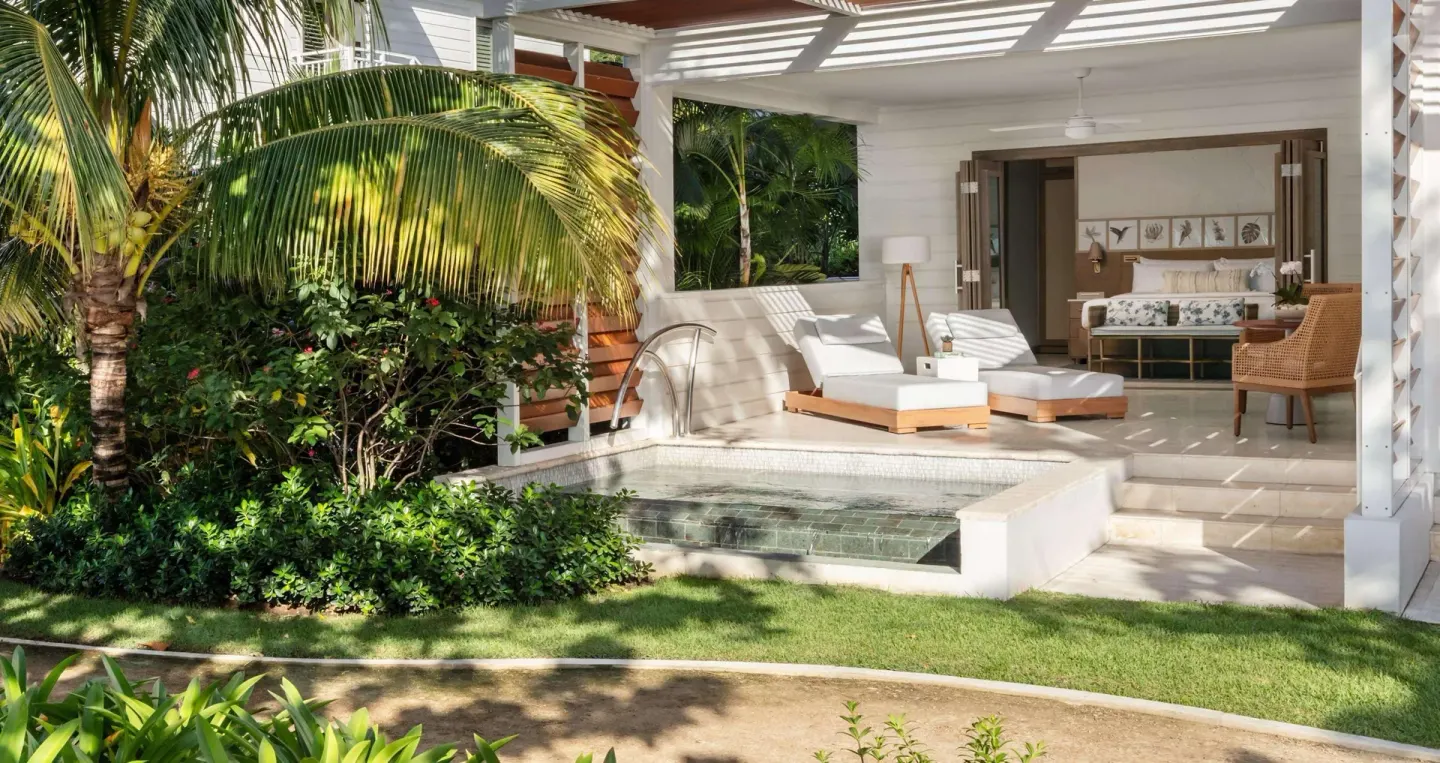 Private patio with plunge pool, loungers, and bedroom beyond at Sandals Halcyon.