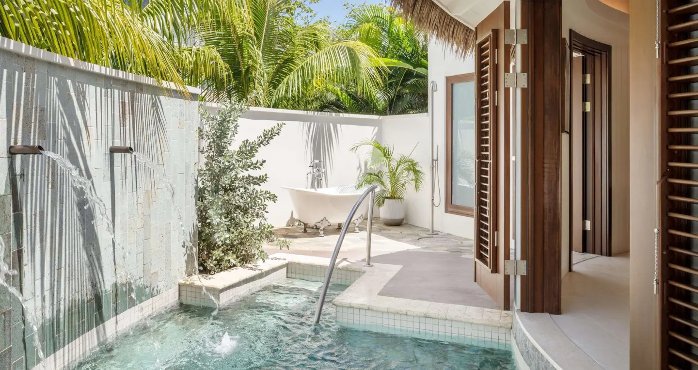 Private plunge pool with water features and outdoor tub at Sandals Halcyon.