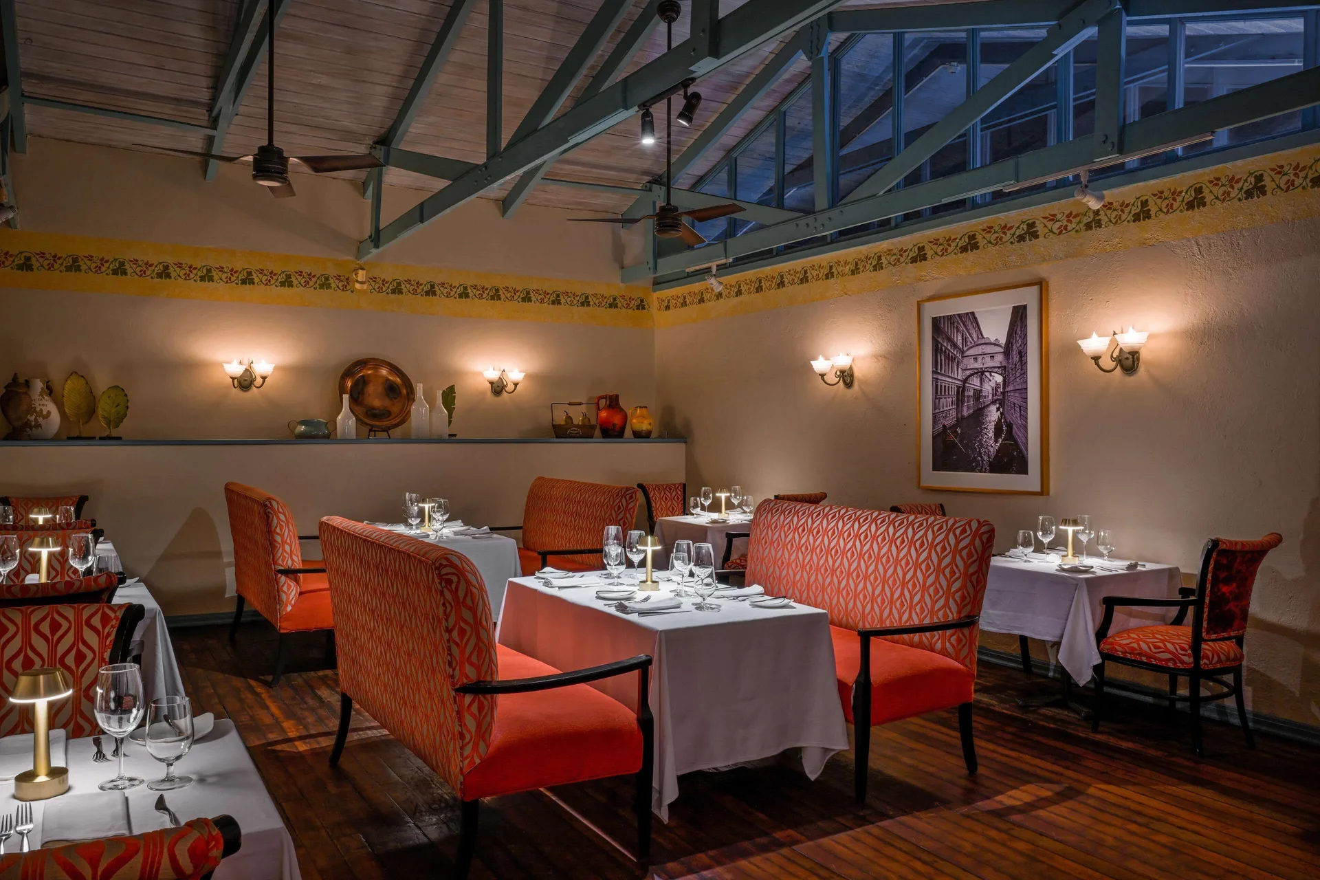 Italian-style dining room with orange banquettes at Sandals Halcyon.