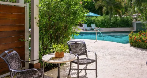 Club Room patio seating beside the swim-up pool at Sandals Halcyon.