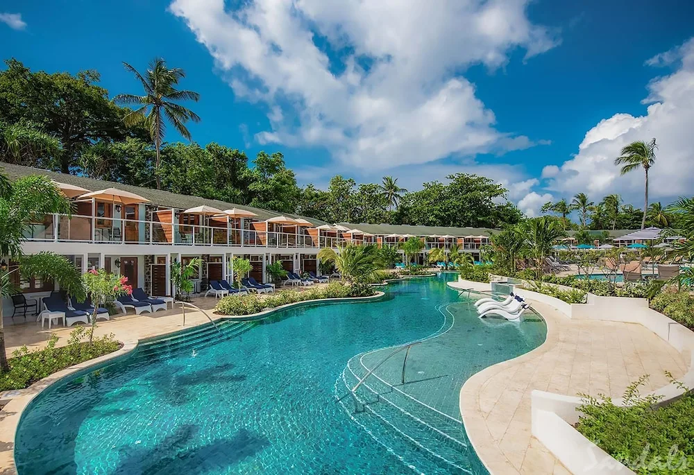 Lagoon pool and poolside guest room buildings at Sandals Halcyon.