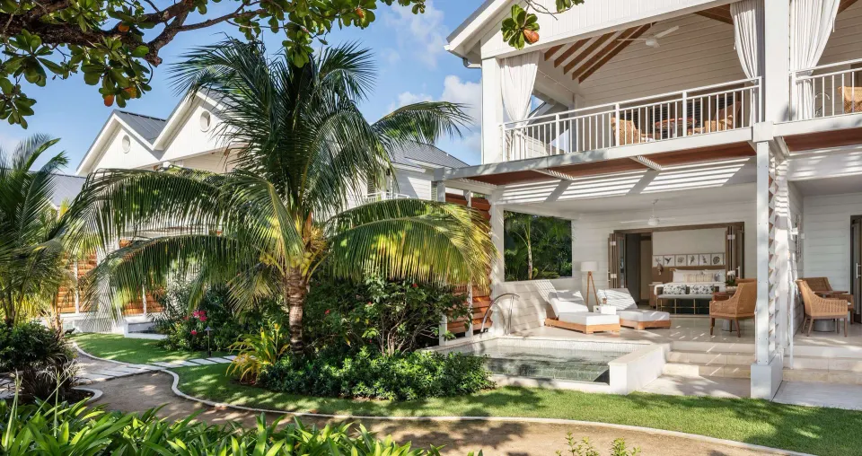 Shore House suite exterior with patio plunge pool and balcony at Sandals Halcyon.